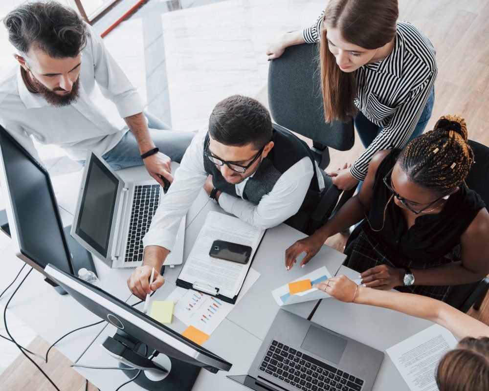 A group of multinational busy people working in the office. Height view