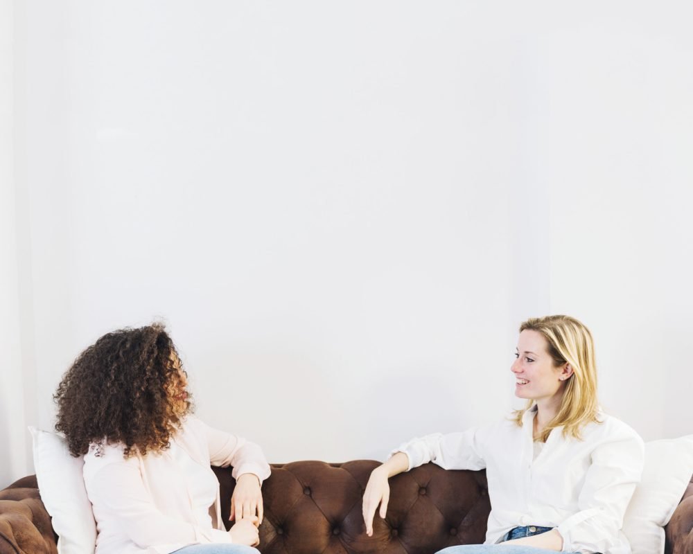 women-speaking-sofa
